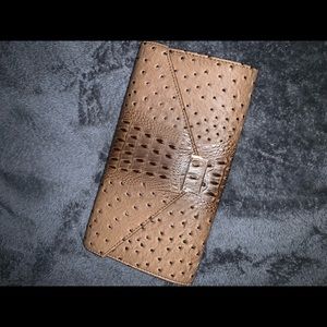Tan Clutch. See photos for measurements. 2 spots on the inside shown in pics.